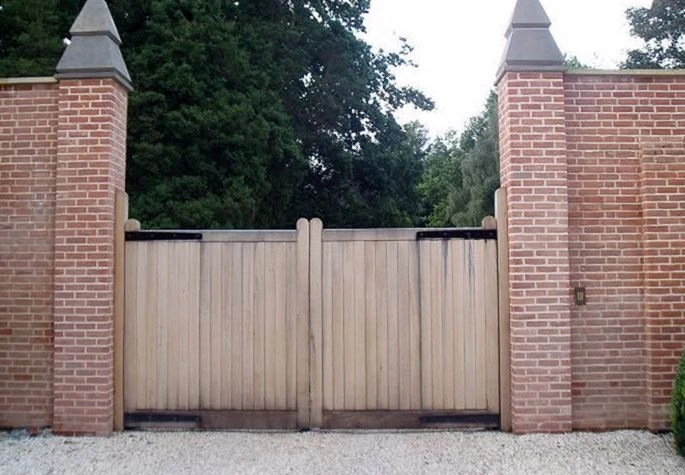 Gate technician repairing a damaged automatic gate